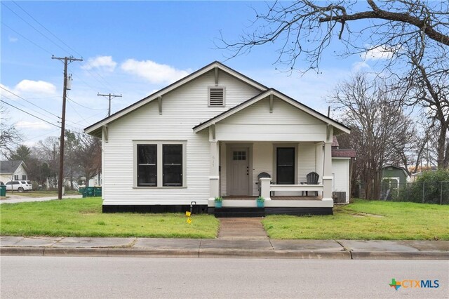 view of front facade with a porch and a front yard