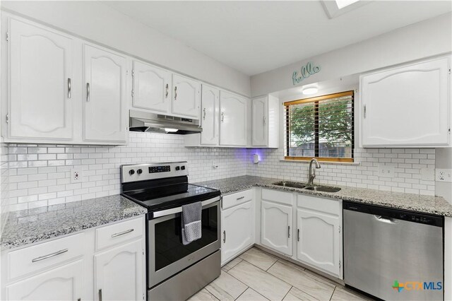 226 Gruene Rd, New Braunfels, TX 78130 - kitchen featuring white cabinets, under cabinet range hood, stainless steel appliances, a sink, and tasteful backsplash