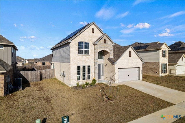 french provincial home with central AC, a front lawn, and solar panels