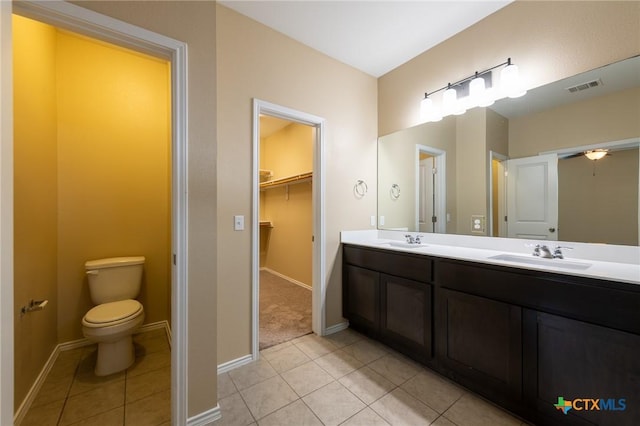 9505 Alex Ln, Austin, TX 78748 - bathroom featuring double vanity, tile patterned flooring, and a walk in closet