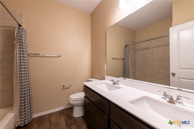 9505 Alex Ln, Austin, TX 78748 - bathroom featuring wood finished floors, double vanity, and shower / bathtub combination with curtain