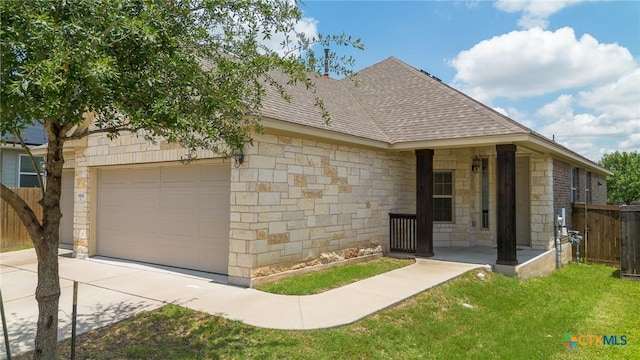 9505 Alex Ln, Austin, TX 78748 - view of home's exterior with an attached garage, stone siding, roof with shingles, and concrete driveway
