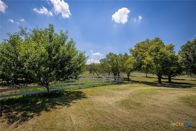 view of home's community featuring a rural view and a lawn