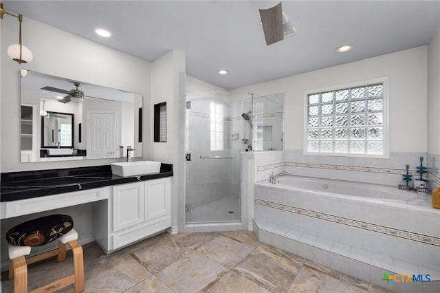 bathroom with vanity, plus walk in shower, and ceiling fan