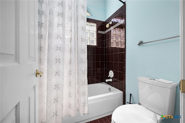 bathroom featuring toilet and shower / tub combo