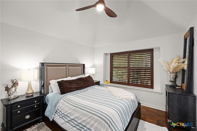 bedroom featuring dark wood-type flooring, lofted ceiling, and ceiling fan