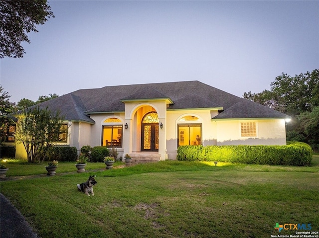 mediterranean / spanish house with a lawn