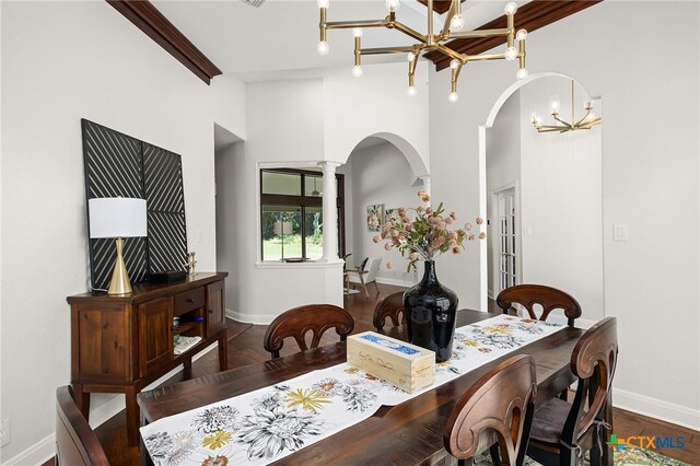 dining area with ornate columns and dark wood-type flooring