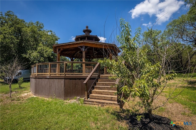 exterior space featuring a wooden deck and a gazebo