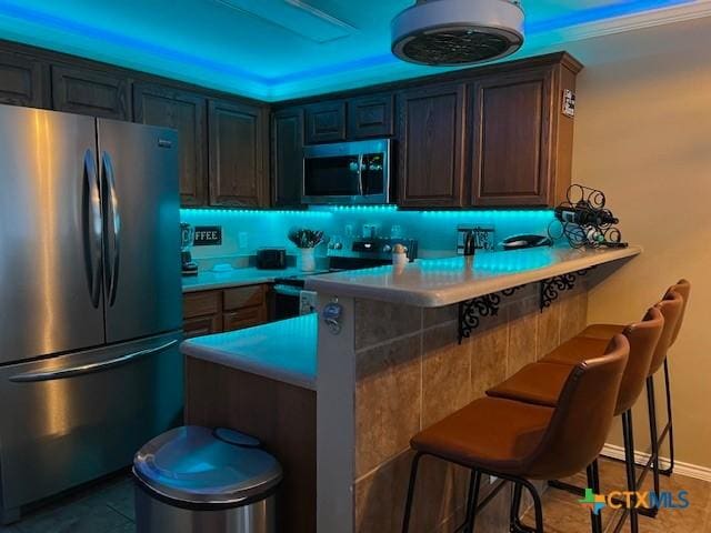 730 E Mather St Unit K203, New Braunfels, TX 78130 - kitchen with appliances with stainless steel finishes, a breakfast bar, a peninsula, and light countertops