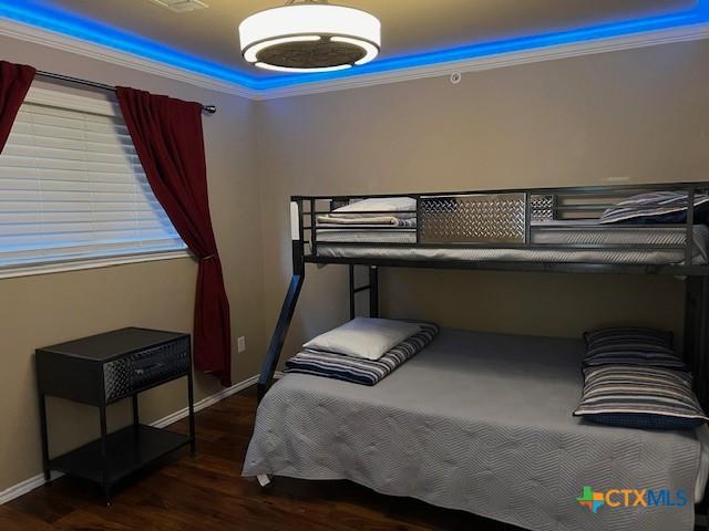 730 E Mather St Unit K203, New Braunfels, TX 78130 - bedroom featuring wood finished floors and crown molding