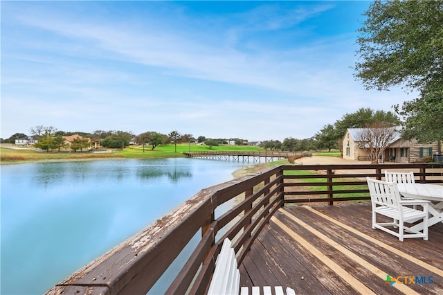 wooden deck featuring a water view