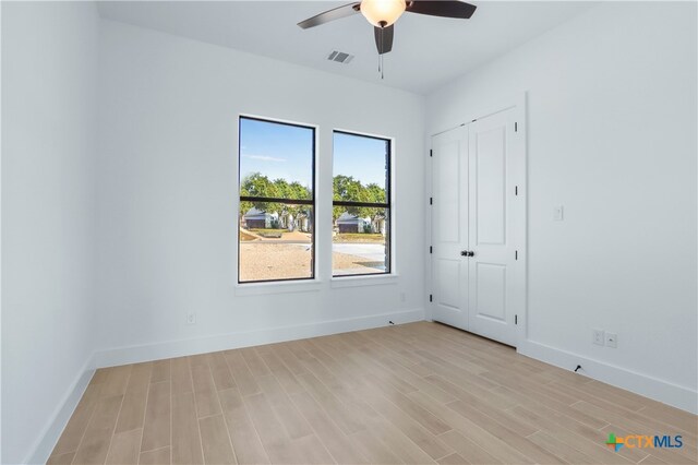 spare room featuring ceiling fan and light hardwood / wood-style flooring