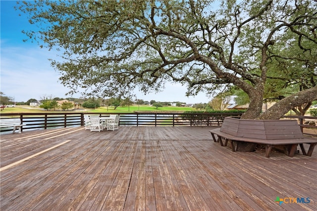 wooden terrace featuring a water view