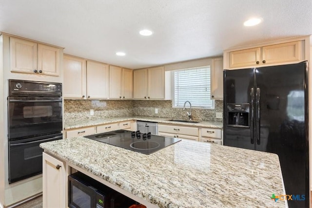 102 Elm Dr, Belton, TX 76513 - kitchen featuring a sink, light brown cabinetry, backsplash, and black appliances