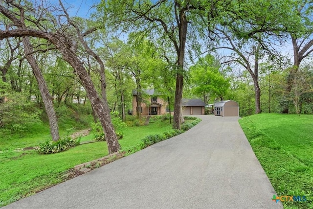 102 Elm Dr, Belton, TX 76513 - view of front of property with a garage, driveway, an outdoor structure, and a front lawn