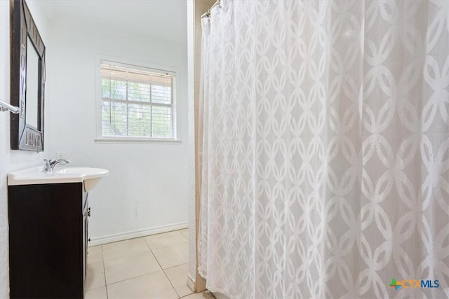102 Elm Dr, Belton, TX 76513 - bathroom with tile patterned flooring, baseboards, curtained shower, and vanity