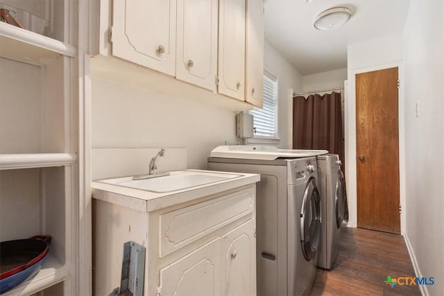 102 Elm Dr, Belton, TX 76513 - laundry room with baseboards, washing machine and dryer, dark wood finished floors, and cabinet space