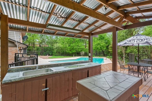 102 Elm Dr, Belton, TX 76513 - wooden terrace featuring an in ground hot tub, an outdoor pool, a sink, fence, and outdoor dining space