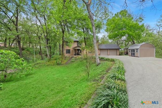 102 Elm Dr, Belton, TX 76513 - view of front of house with a shed, an outbuilding, a front lawn, and a garage