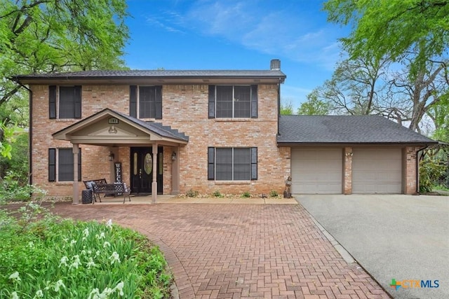 102 Elm Dr, Belton, TX 76513 - colonial inspired home featuring an attached garage, a chimney, driveway, and brick siding