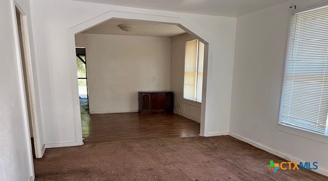 spare room with dark wood-type flooring