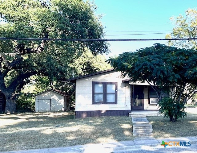 view of front of house featuring a storage shed