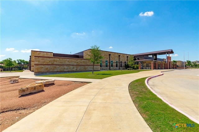 view of property's community with a lawn