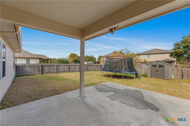 view of patio / terrace featuring a storage shed and a trampoline