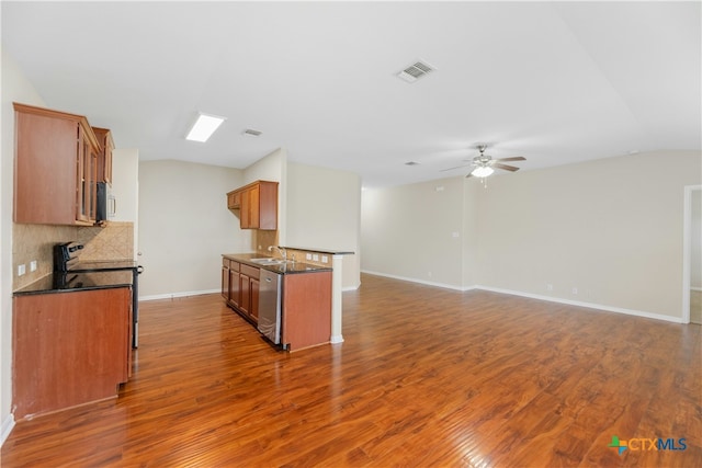 kitchen with sink, stainless steel dishwasher, dark hardwood / wood-style floors, range with electric stovetop, and backsplash