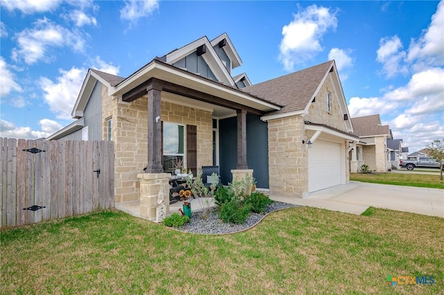 111 Dripping Spg, Victoria, TX 77904 - view of front of home featuring driveway, a garage, stone siding, board and batten siding, and roof with shingles