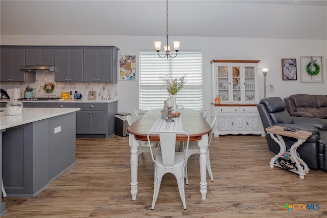 111 Dripping Spg, Victoria, TX 77904 - dining area with a chandelier and light wood-type flooring