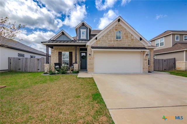 111 Dripping Spg, Victoria, TX 77904 - craftsman-style house featuring a standing seam roof, concrete driveway, stone siding, covered porch, and a metal roof