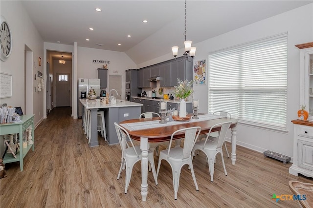111 Dripping Spg, Victoria, TX 77904 - dining room featuring light wood finished floors, lofted ceiling, recessed lighting, and a chandelier