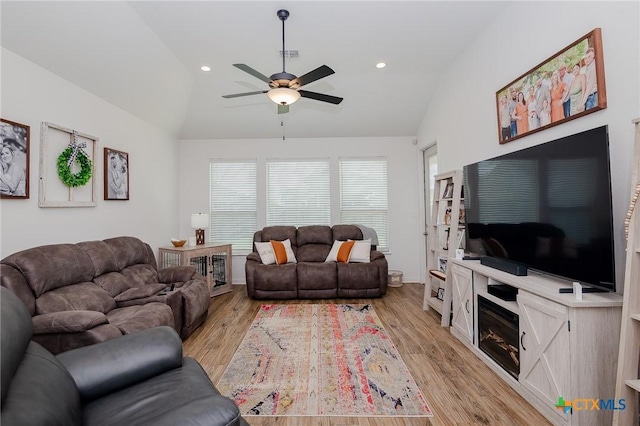 111 Dripping Spg, Victoria, TX 77904 - living room with lofted ceiling, ceiling fan, light wood-style floors, and a glass covered fireplace