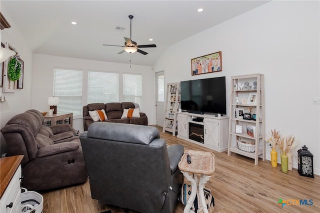 111 Dripping Spg, Victoria, TX 77904 - living area with vaulted ceiling, a ceiling fan, light wood finished floors, a fireplace, and recessed lighting