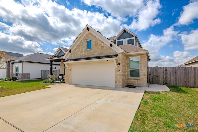 111 Dripping Spg, Victoria, TX 77904 - craftsman house with stone siding, driveway, an attached garage, and a standing seam roof