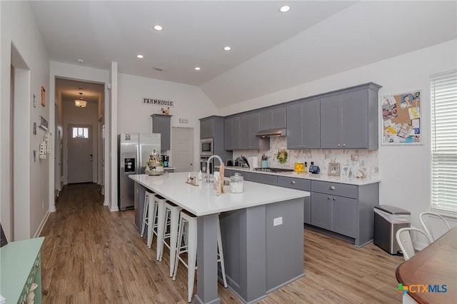 111 Dripping Spg, Victoria, TX 77904 - kitchen featuring appliances with stainless steel finishes, gray cabinets, under cabinet range hood, light wood finished floors, and recessed lighting