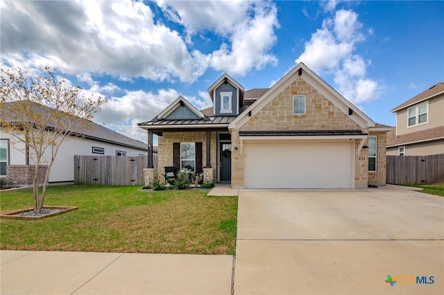 111 Dripping Spg, Victoria, TX 77904 - craftsman inspired home featuring driveway, a standing seam roof, stone siding, and an attached garage
