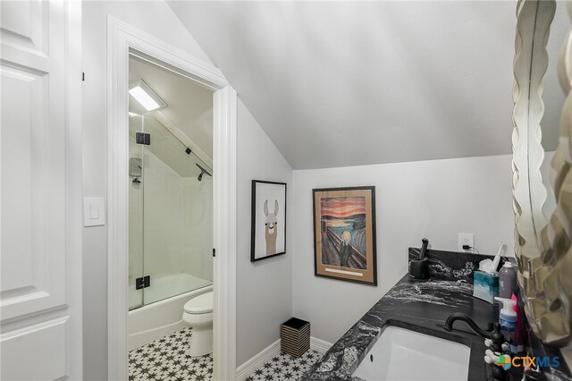 full bathroom with tile patterned flooring, enclosed tub / shower combo, vanity, lofted ceiling, and toilet