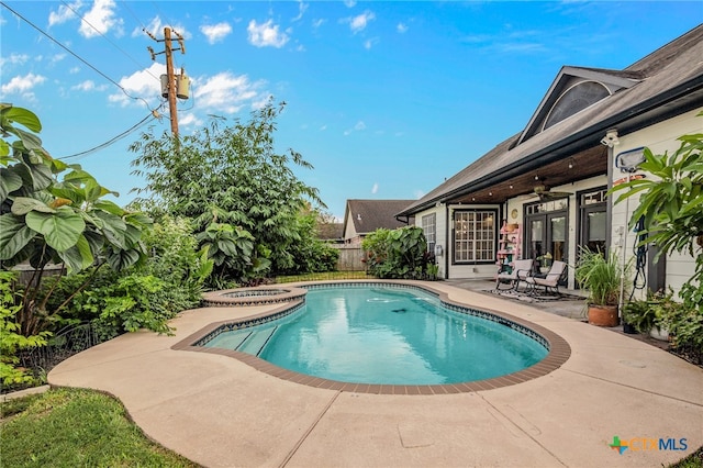 view of swimming pool featuring ceiling fan and a patio area