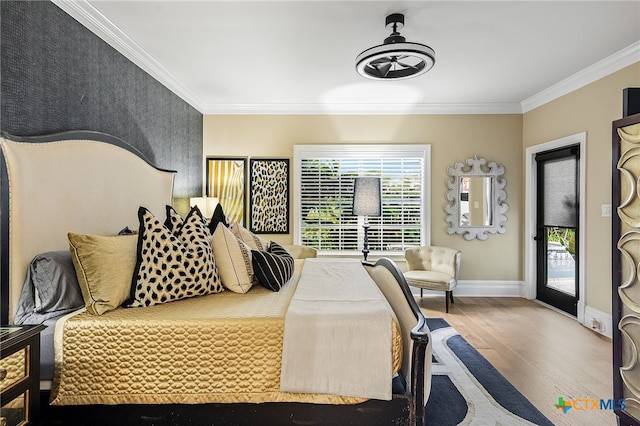 bedroom featuring hardwood / wood-style flooring, ornamental molding, and access to exterior