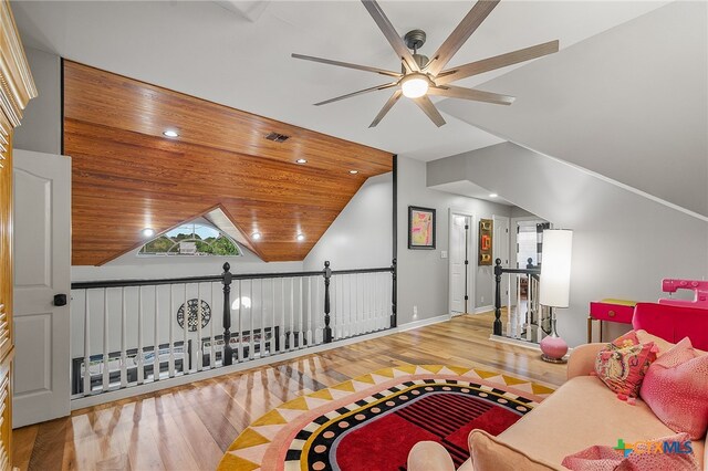 living room with ceiling fan, wood-type flooring, vaulted ceiling, and wooden ceiling