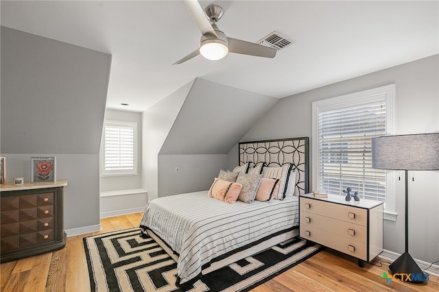 bedroom with ceiling fan, light hardwood / wood-style flooring, and lofted ceiling