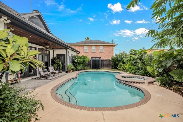 view of pool featuring an in ground hot tub, french doors, and a patio area