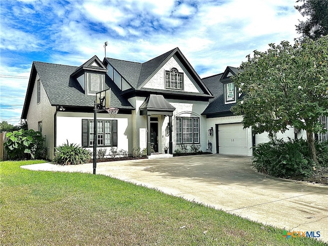 view of front of property with a garage and a front lawn