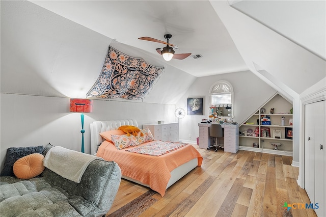 bedroom with ceiling fan, light wood-type flooring, and lofted ceiling