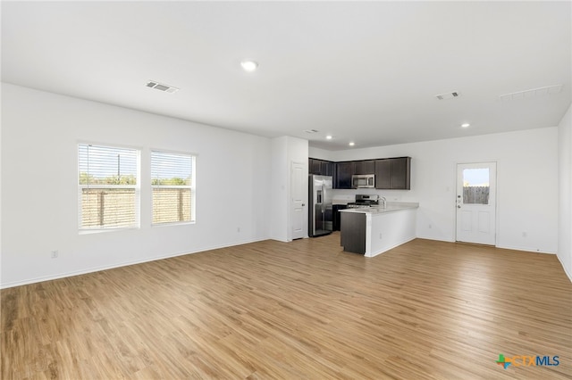 unfurnished living room with light wood-type flooring