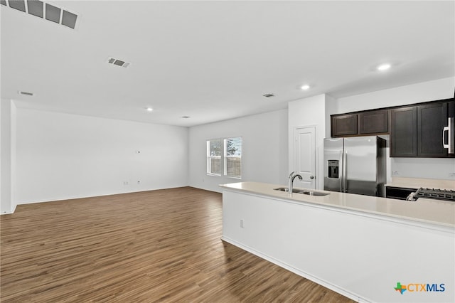 kitchen with hardwood / wood-style floors, dark brown cabinets, sink, and stainless steel appliances