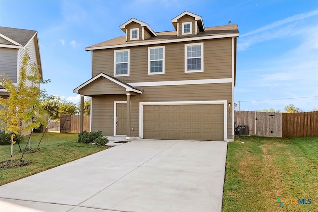 view of front of house featuring a garage, a front lawn, and cooling unit